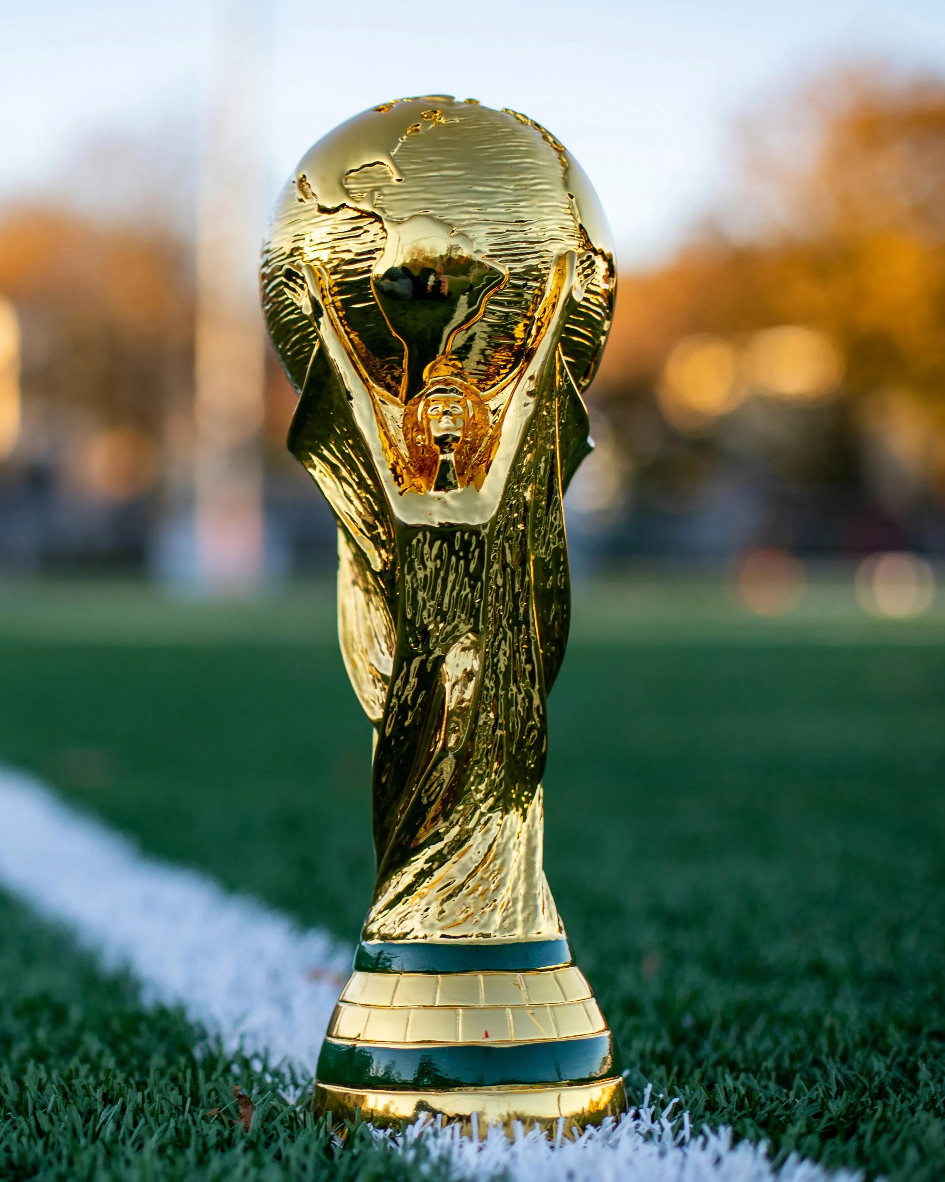 FIFA World Cup style trophy on pitch before the 2026 football tournament.